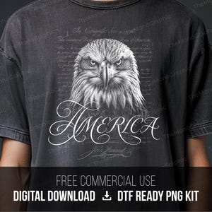 May include: Dark grey t-shirt with a detailed black and white illustration of an eagle's head and the word "AMERICA" in script. The design also includes text from the Declaration of Independence.