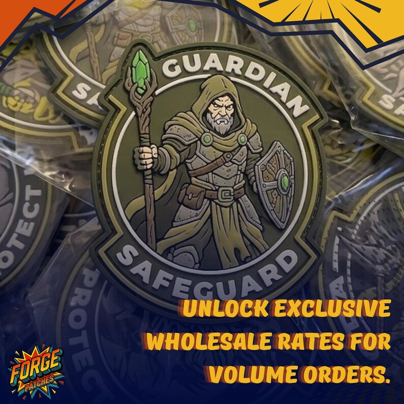 May include: A circular olive green PVC patch featuring a bearded hooded figure holding a staff with a green crystal and a shield. The text GUARDIAN is arched at the top and SAFEGUARD is at the bottom. The design includes brown and grey armour details.