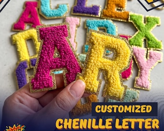 May include: A collection of colorful chenille letter patches with gold glitter borders. The letters are available in various bright colors including hot pink, yellow, light blue, purple, orange, green, and light pink, featuring a fuzzy texture.