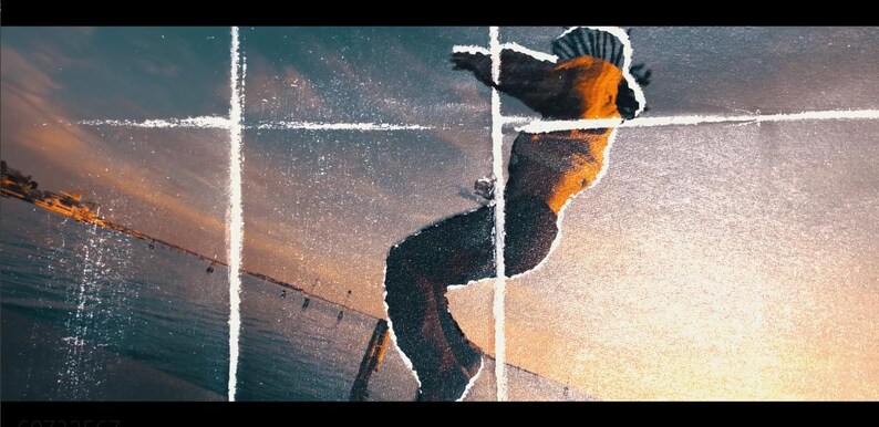 May include: An artistic image of a person in motion, silhouetted against a sunset sky. The figure is wearing a hat and dark pants, with arms outstretched. The background features a bridge and water, with a textured, artistic overlay.