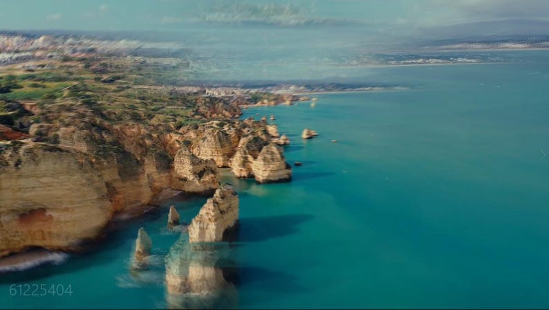 May include: Aerial view of a coastline with turquoise water and rocky cliffs. The cliffs are a light tan color, and the water is a vibrant blue. The sky is a pale blue with some clouds. The image has a natural, scenic feel.