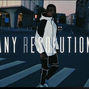 May include: A person wearing a white and black reflective jacket and black pants, standing on a crosswalk. The words "ANY RESOLUTION" are displayed in large white letters. The background shows a city street at dusk.