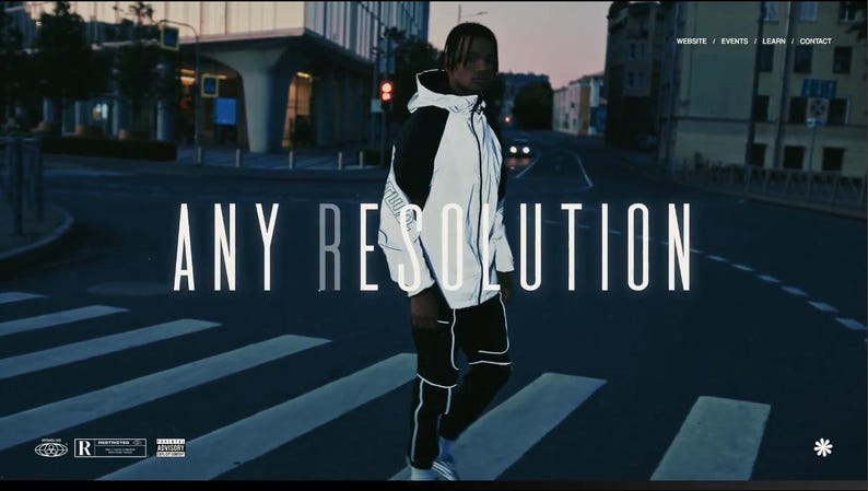 May include: A person wearing a white and black reflective jacket and black pants, standing on a crosswalk. The words "ANY RESOLUTION" are displayed in large white letters. The background shows a city street at dusk.