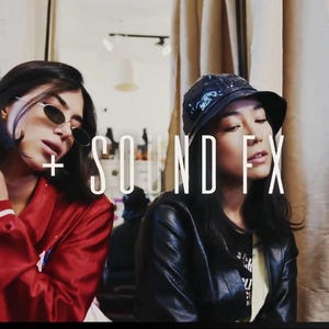 May include: Two people are featured in this image. One is wearing a red jacket with white accents and sunglasses. The other is wearing a black leather jacket and a bucket hat. The text "+ SOUND FX" is overlaid on the image.