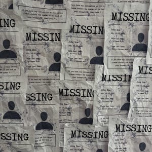 May include: A collage of multiple crumpled white paper flyers with black text and graphics. Each flyer features the word MISSING in bold, a generic black silhouette of a person, and text including John Doe, DOB: 02.02.1922, Date Last Seen: Halloween Night, and Place Last Seen: Desired Address Here.
