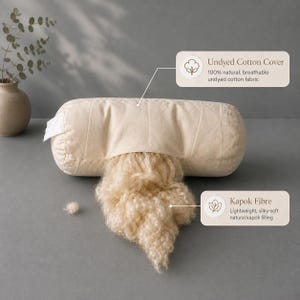 May include: A cylindrical bolster pillow with an undyed cotton cover and exposed light tan kapok fiber filling. Text labels indicate: Undyed Cotton Cover, 100% natural, breathable undyed cotton fabric, and Kapok Fibre, lightweight, silky-soft natural kapok filling.
