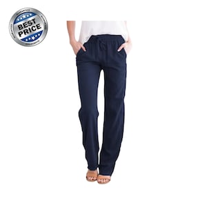 May include: Navy blue trousers featuring an elasticized waistband with a drawstring closure, two side pockets, and a straight-leg silhouette. The pants are paired with a white top and tan sandals, and a circular badge reads BEST PRICE.