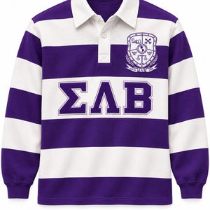 May include: A long-sleeve rugby shirt featuring horizontal purple and white stripes, a white collar, and a button placket. The chest displays the Greek letters ΣΛΒ in purple with white outlines, and a crest with the text April 4th ΣΛΒ 1986.
