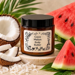 May include: A brown glass jar with a black lid containing Coco Melon Body Butter. The white label features black text and a botanical border. The jar is surrounded by fresh coconut pieces, shredded coconut, and slices of red watermelon.