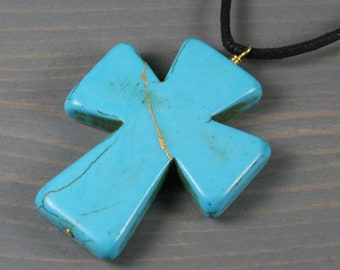 Kintsugi repaired turquoise howlite cross pendant on black cotton cord