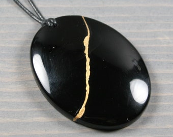 Kintsugi repaired black onyx pendant on black cotton cord