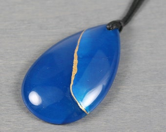 Kintsugi repaired blue agate teardrop pendant on an adjustable length black cotton cord necklace