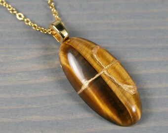 Kintsugi repaired tiger eye pendant on a cable chain necklace