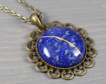 Kintsugi repaired lapis lazuli pendant with an antiqued brass setting on cable chain