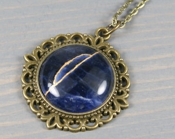 Kintsugi repaired sodalite pendant with an antiqued brass setting on cable chain