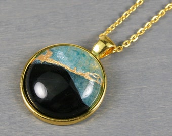 Kintsugi repaired teal druzy and black agate pendant in a gold plated bezel setting on a chain necklace