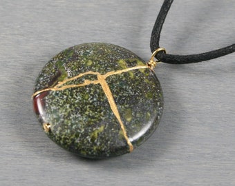 Kintsugi repaired dragon blood jasper pendant on an adjustable length black cotton cord necklace