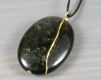 Kintsugi repaired golden sheen obsidian pendant on and adjustable length black cotton cord necklace