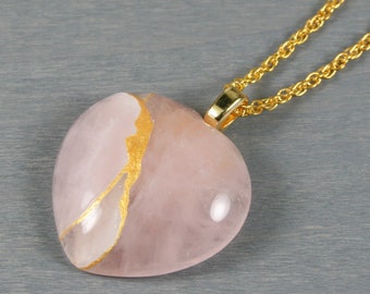 Large rose quartz broken heart pendant with kintsugi repair on a rope chain necklace
