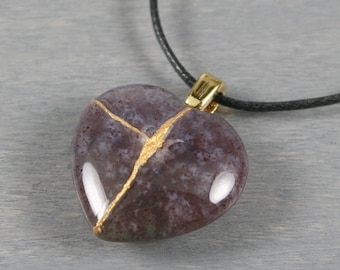 Kintsugi repaired Indian agate broken heart pendant on a black cotton cord necklace