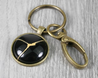 Kintsugi repaired black agate key chain with an antiqued brass swivel lobster claw