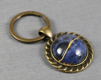 Petite kintsugi repaired sodalite key chain with an antiqued brass key ring