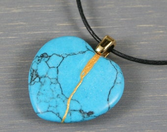 Broken heart pendant in turquoise blue magnesite stone with kintsugi repair on black cotton cord