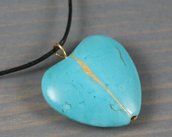 Turquoise howlite broken heart pendant with kintsugi repair on black cotton cord