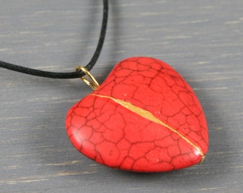 Red howlite broken heart pendant with kintsugi repair on black cotton cord