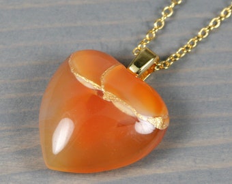 Broken heart pendant in carnelian with kintsugi repair on a cable chain necklace