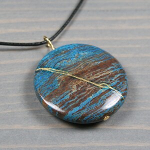 Kintsugi repaired blue sky jasper pendant on black cotton cord