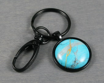 Kintsugi repaired turquoise howlite key chain in a black bezel setting with swivel lobster claw