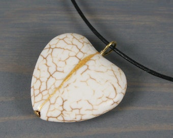 White howlite broken heart pendant with kintsugi repair on black cotton cord