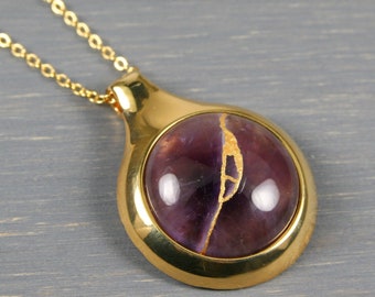 Kintsugi repaired amethyst pendant in a gold plated setting on a cable chain necklace