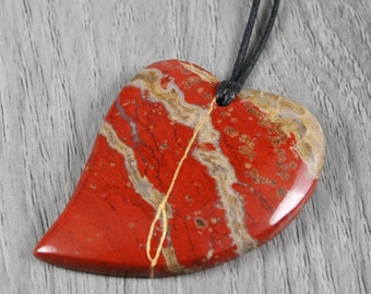 Kintsugi repaired brecciated jasper broken heart pendant on and adjustable length black cotton cord