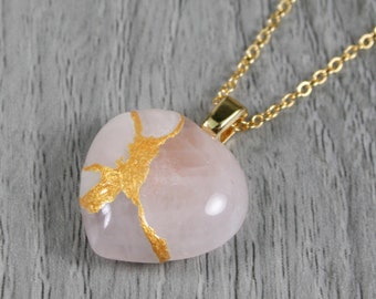 Broken heart pendant in rose quartz with kintsugi repair on a cable chain necklace