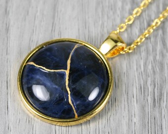 Kintsugi repaired sodalite pendant in a gold plated bezel setting on a chain necklace