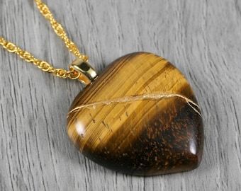 Kintsugi repaired tiger eye broken heart pendant on a rope chain necklace