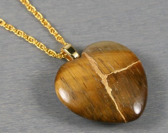 Kintsugi repaired tiger eye broken heart pendant on a rope chain necklace