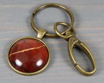 Kintsugi repaired red tiger eye key chain with an antiqued brass swivel lobster claw