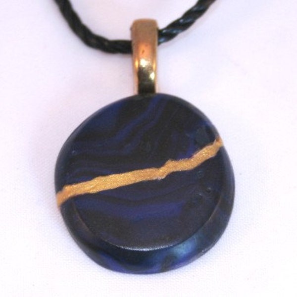 CLEARANCE SALE - Kintsugi style circle pendant in blue and black polymer clay with gold repair - OOAK