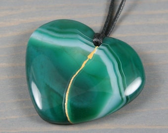 Kintsugi repaired green banded agate broken heart pendant on an adjustable black cotton cord necklace