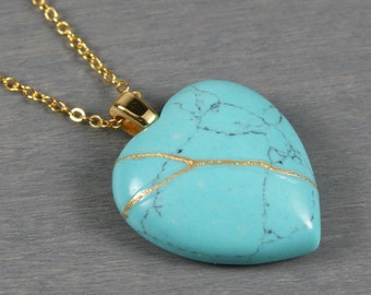 Broken heart pendant in imitation turquoise with kintsugi repair on a cable chain necklace