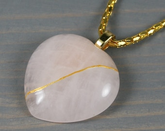 Large rose quartz broken heart pendant with kintsugi repair on a cable chain necklace