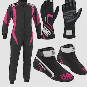 May include: A black and pink racing suit with OMP branding, a pair of black and pink racing gloves with OMP and FIRST logos, and a pair of black and pink racing boots with white ankle straps and OMP branding on the sides and heels.