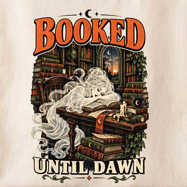 May include: A graphic print featuring the text BOOKED UNTIL DAWN with a translucent figure resting on an open book at a wooden desk. The scene includes stacks of vintage books, a lit candle, a mug, and a library background with a window view.
