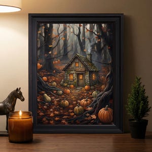May include: A framed wall art print depicting a stone cottage in a dark forest filled with orange pumpkins and fallen autumn leaves. The cottage features a chimney with smoke, glowing windows, and a sign above the door that reads COTTAGE.