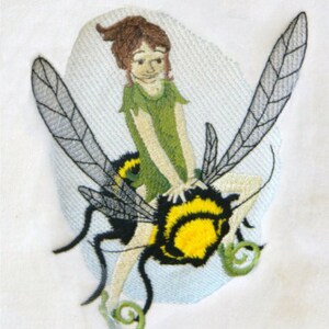 May include: Embroidered design of a fairy riding a bee. The fairy is wearing a green dress and has brown hair. The bee is black and yellow with wings.
