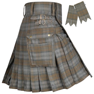 May include: A pleated kilt in a grey and brown plaid pattern featuring a large cargo pocket with gold-toned snap buttons, two adjustable side straps with metal buckles, and a pair of matching tartan flashes for socks or hose.