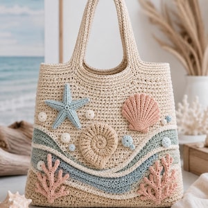 May include: A beige crochet tote bag featuring a textured design with a light blue starfish, a pink scallop shell, a tan spiral shell, and two pink coral accents. The bag includes wavy bands of light blue and sage green yarn across the lower section.